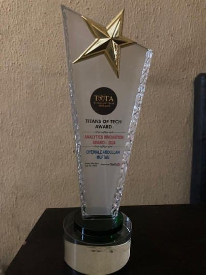 Titans of Tech Analytics Innovation Award 2024 crystal plaque engraved with Oyewale's name